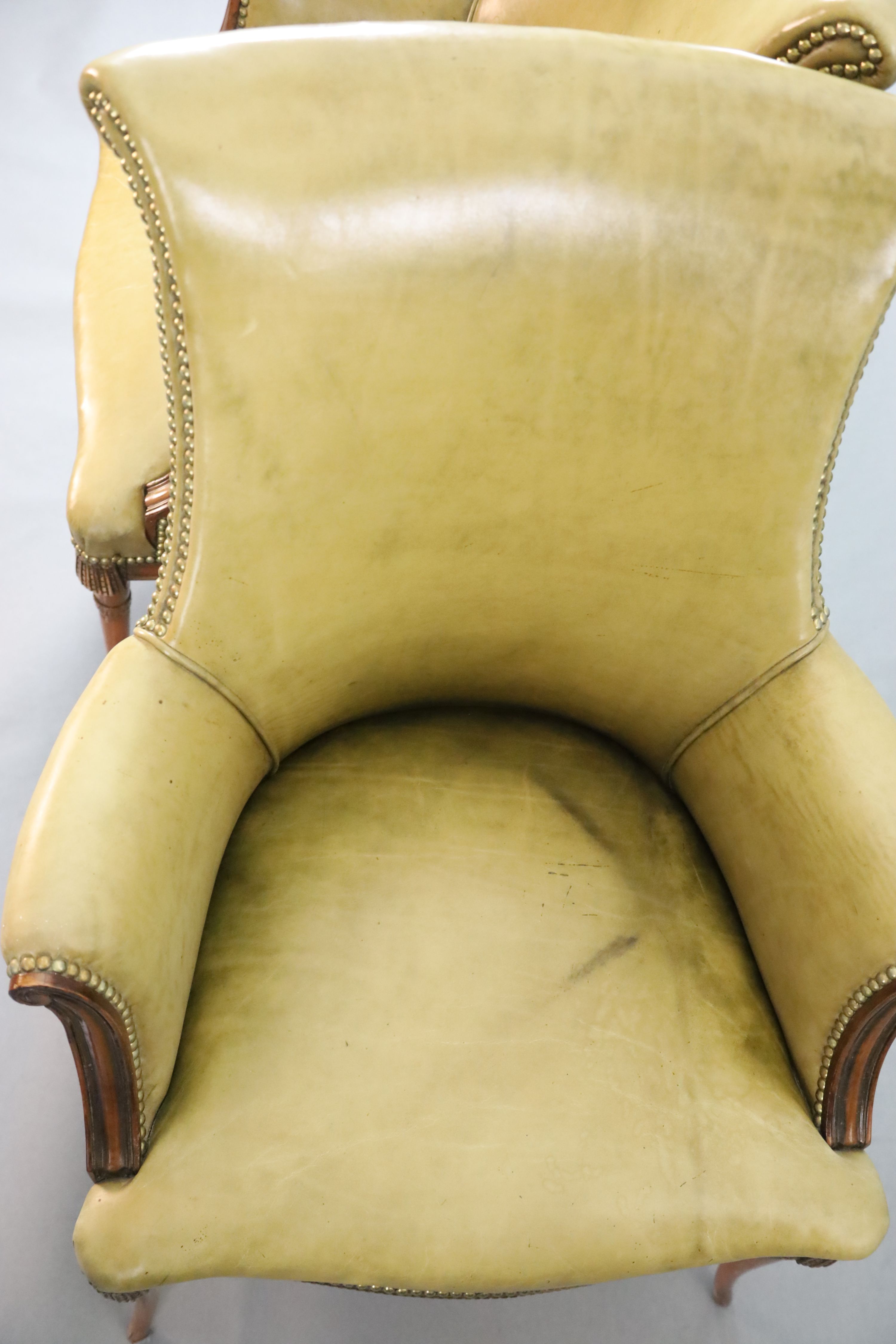 A pair of Regency style leather and mahogany library chairs, W.2ft 3in. D.2ft 3in. H.3ft 2in.